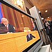 Журналисты слушают выступление Президента России Владимира Путина с ежегодным посланием к Федеральному собранию России (на экране телевизора) в холле Мраморного зала Московского Кремля